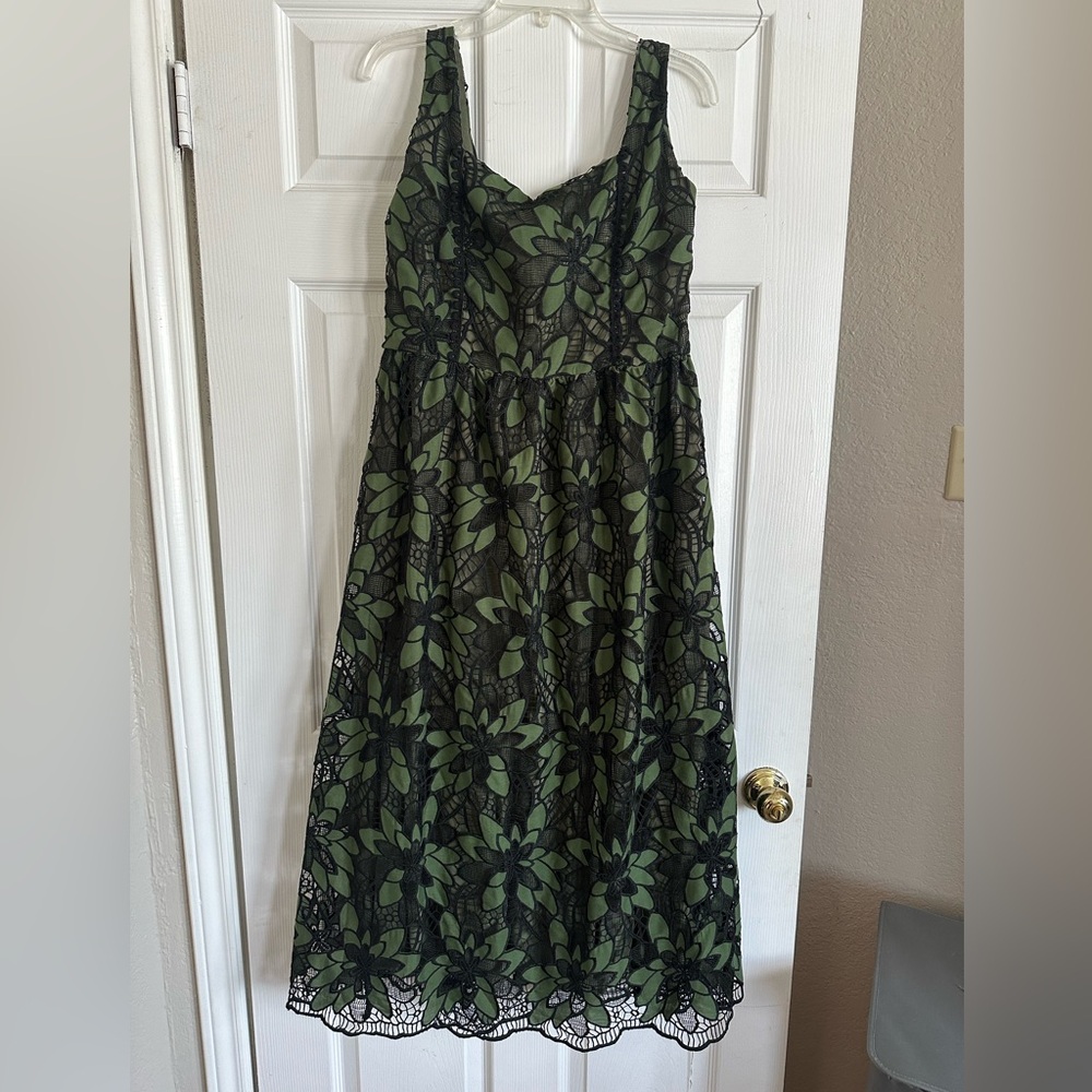 Beautiful black and green lace, with a corset-style back. Never worn, size XL